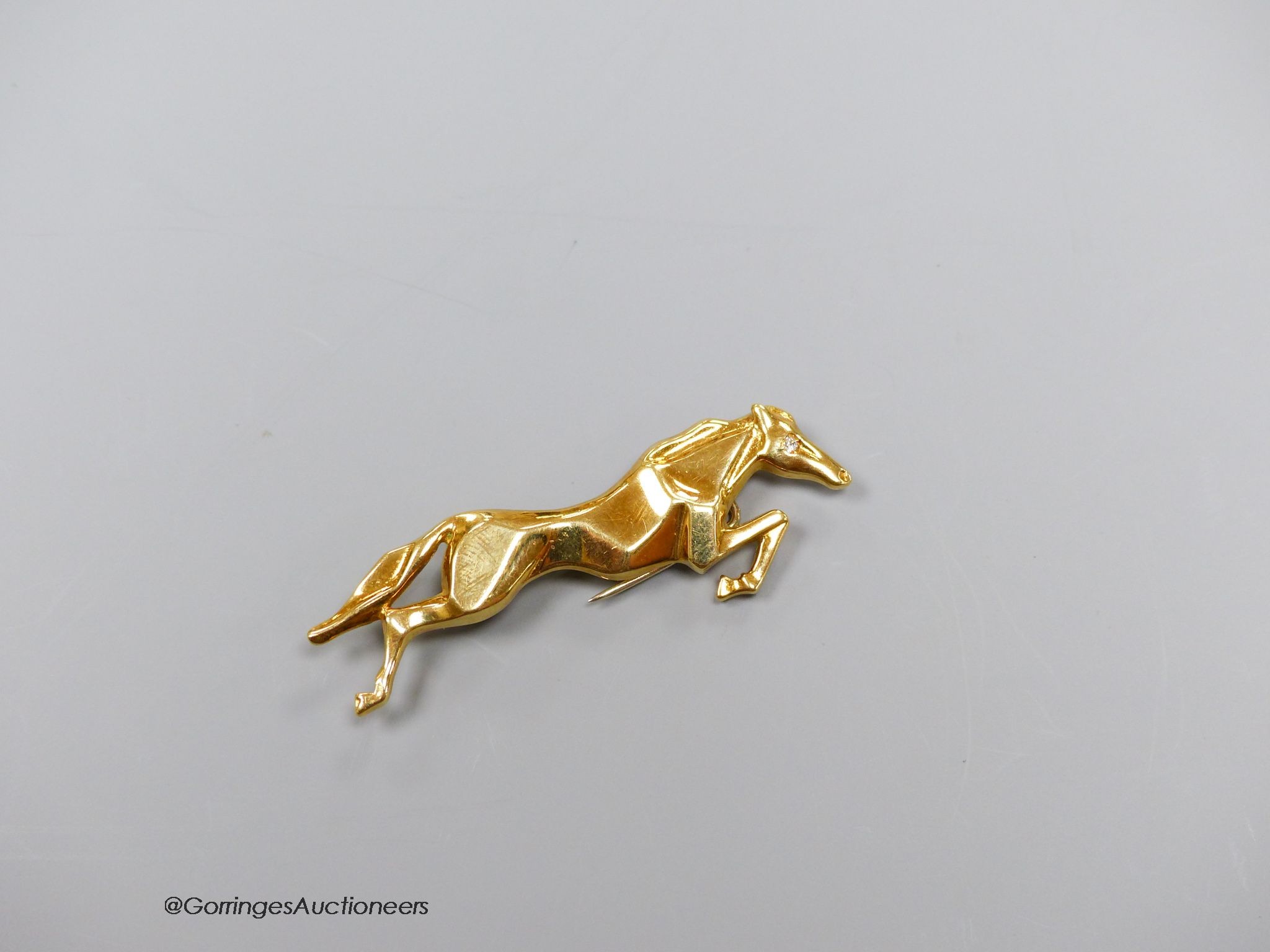An 18k gold (750) diamond set horse brooch, gross 6.3g, 5cm.